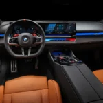 Green BMW M5 in Luxe AF Motors Warehouse in Houston, Texas