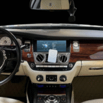 A black Rolls Royce Ghost rental in Houston parked indoors, showcasing its elegant and sophisticated design.