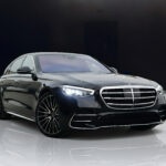 A black Mercedes-Benz S580 AMG luxury sedan parked outdoors, showcasing its elegant and powerful appearance.