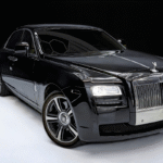 A black Rolls Royce Ghost rental in Houston parked indoors, showcasing its elegant and sophisticated design.