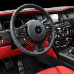 Rolls Royce Cullinan Black Badge driver cockpit with red leather and technical carbon fiber dash