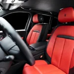Bespoke red leather seats in Rolls Royce Cullinan with starlight headliner visible