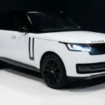 Land Rover Range Rover in white, showing sporty SUV profile and bold front grille.